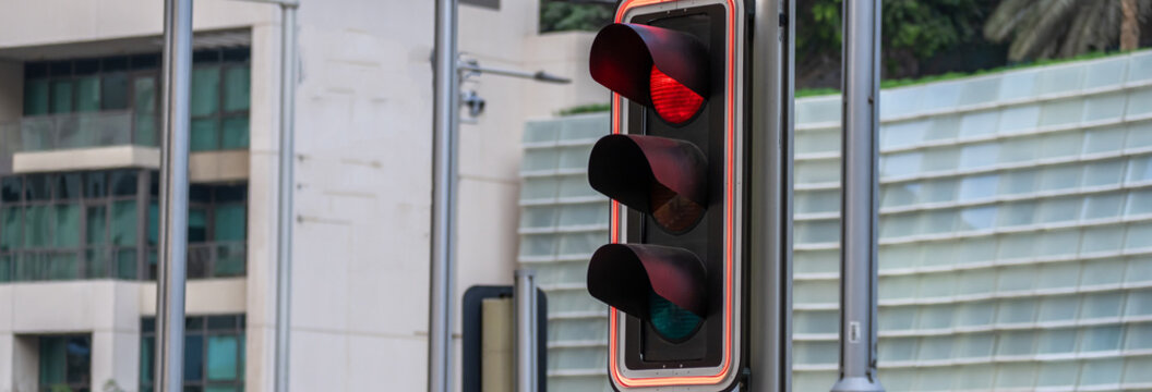 Red traffic light illuminated on a signal, indicating stop for vehicles, symbolizing road safety, traffic control, and regulated urban transportation flow at intersections.