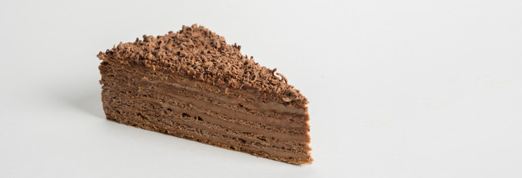 A Micado piece, a small, crispy, chocolate-coated biscuit stick, perfect for snacking, dessert accompaniment, or sweet indulgence.