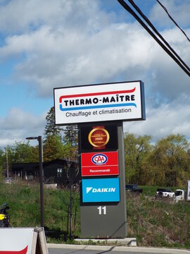 Gatineau, Quebec, Canada &ndash; May 13, 2026: A vertical roadside sign displays the "Thermo-Ma&icirc;tre logo, 2025 Consumer Choice Award, CAA recommendation, and Daikin brand branding" on Boulevard Saint-Joseph