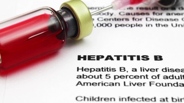 Hepatitis B Vaccine and Syringe on Medical Document Close-Up