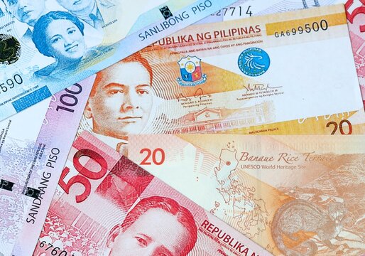 Philippine peso money bills in pile on table. Philippines PHP currency cash close up