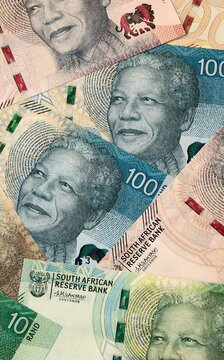 South African rand money bills in pile on table. South Africa ZAR currency cash close up