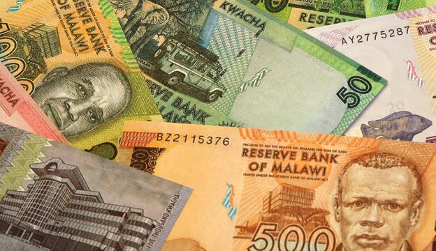 Malawian kwacha money bills in pile on table. Malawi MWK currency cash close up