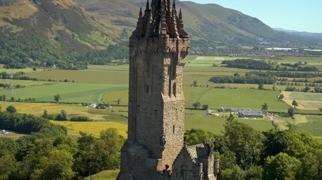 Aerial view rising up the National Wallace Monument, revealing the historic Stirling countryside