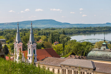 Fototapeta premium A panorama of Esztergom, Hungary. View of the towers of St. Ignatius Church in the Watertown district, the dome of the Esztergom Basilica, and the Danube River.
