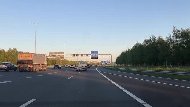 Amsterdam Netherlands highway, Evening motorway traffic with cars and truck under sunset light