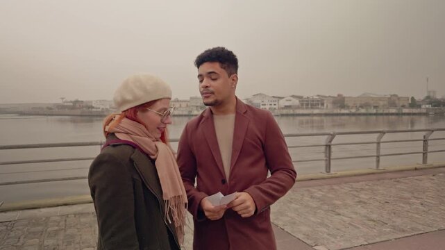Young couple discussing having a conversation outdoors