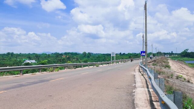 Ho Quang Thanh rides on highway in Dong Nai Vietnam on a sunny day