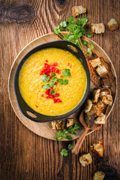 Traditional Indian style dal lentil soup dal tadka with roasted flatbread served as top view in a design pot