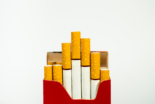 Close up of red pack of cigarettes with yellow filters cigarette addiction nicotine unhealthy close-up abstinence lifestyle