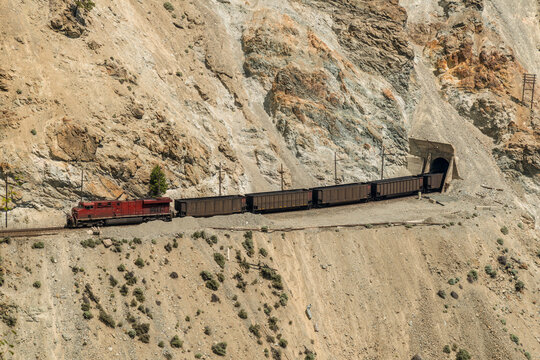 Canada, BC, Spences Bridge.  Coal train passes through various tunnels and slide sheds on the edge of the Thompson Canyon.