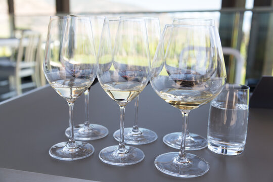 Canada, BC, Okanagan Valley.  Wine glasses prepared for white wine tasting at winery.  The Okanagan Valley is the premier wine growing region in Canada.