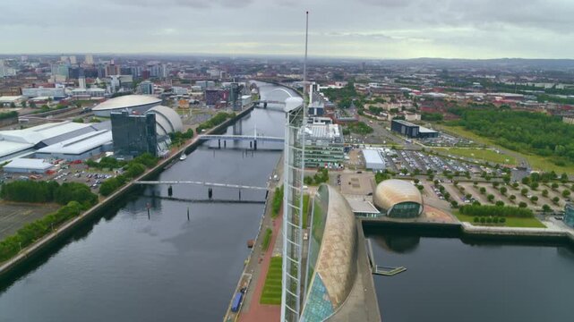 Aerial footage moving past the Glasgow Tower revealing the city skyline and the River Clyde