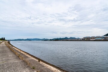 Fototapeta premium Mihara, Japan on a very cloudy day. The area along the Mihara Port on the Setonaikai Sea in in the prefecture of Hiroshima, Japan