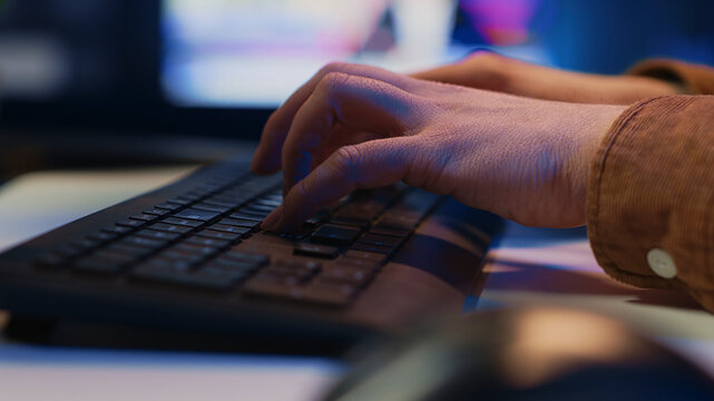 Computer peripheral used by IT admin to type lines of code on desktop PC in apartment, close up shot of keyboard used by software engineer programming at home.