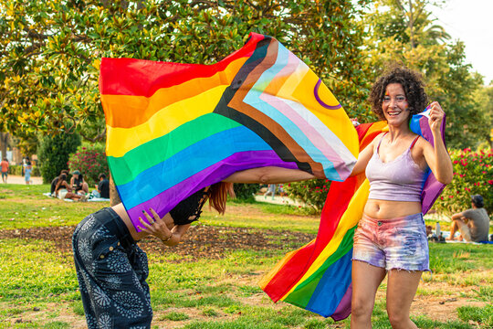 Diverse women celebrating pride at an outdoor festival