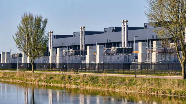 Middenmeer, Netherlands - 14 April 2026: View of Microsoft Datacenter Western Europe with its emergency backup diesel powerplants and exhaust stacks under a clear blue sky.