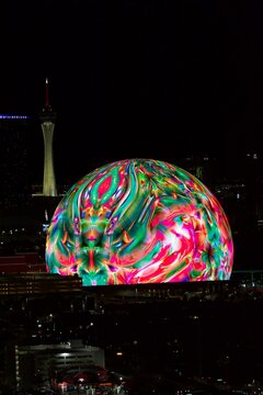 Las Vegas, Nevada, United States - July 23rd, 2025: The Las Vegas Sphere immersive theater close up at night with trippy colorful art video on outside
