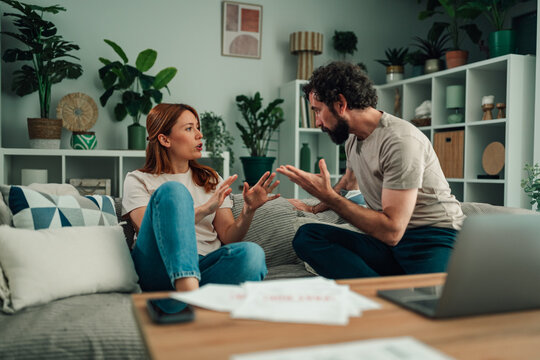 Couple having conflict about relationship problems and financial stress at home, arguing and yelling