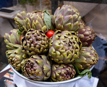 Fresh artichokes by entrance in kosher restaurant in Jewish Quarter of Rome in the Sant'Angelo neighborhood, ingredient of Jewish-style Roman artichokes or carciofi alla giudia