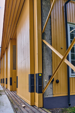 Karlskrona, Sweden - 16 September 2025: View of the massive yellow wooden sliding doors of a historic hangar on Stumholmen island, featuring industrial tracks and structural supports.