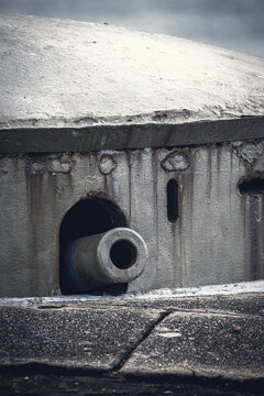 Rio de Janeiro, Brazil - 02 June 2026: View of a cannon barrel protruding from a weathered concrete bunker at the historic Copacabana Fort.
