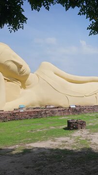 The Reclining Buddha statue at Ayutthaya, Thailand, is a sacred Buddhist monument. Depicts Buddha in a state of parinirvana, symbolizing his final entry into nirvana.