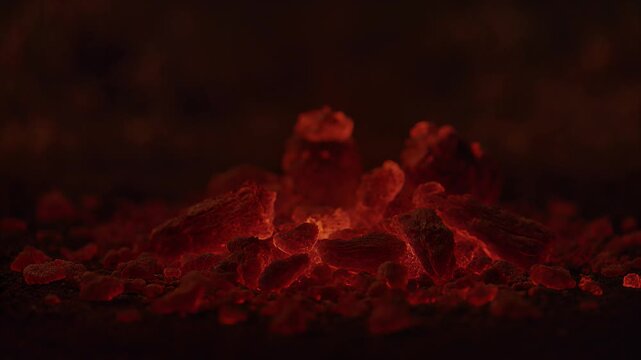 Close up view of glowing red hot embers in a dying campfire