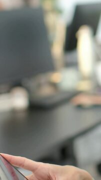 Vertical video: Tapping cuffed hands swiping, adjusting grip at office desk, with phone, copy space