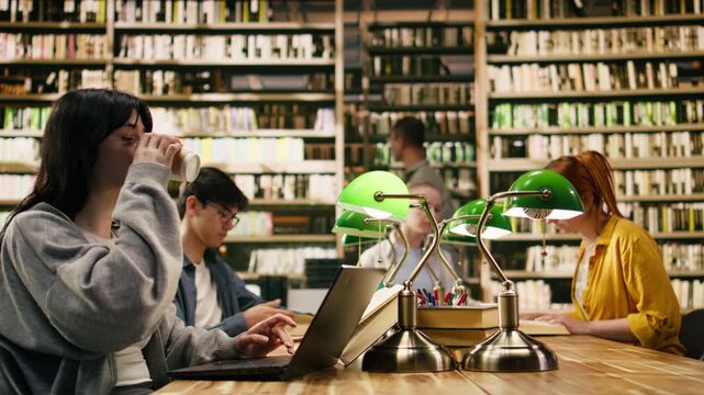 Frustrated woman student scratching head and drinking coffee, feeling exam stress and pressure while taking notes with open book and laptop.