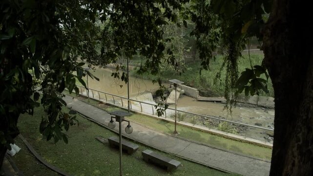 point of view of the access road in the city forest, beside it there is a flowing river