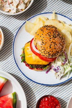Homemade Cheeseburger with Barbecue Food and Sides