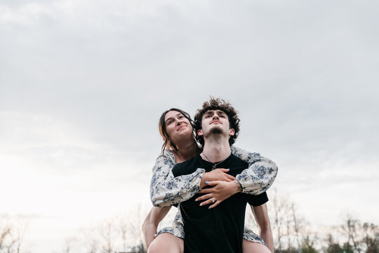 A brother and sister having fun together while posing for family photos. 