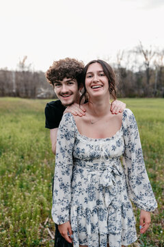 A brother and sister having fun together while posing for family photos. 