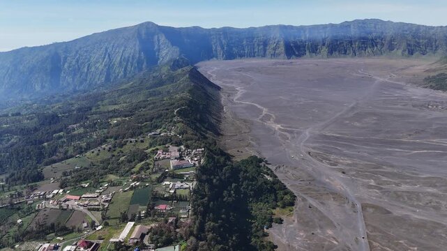 Aerial view of Cemoro Lawang village is propped on a protruding ledge at the base of Mount Bromo in East Java, Indonesia.