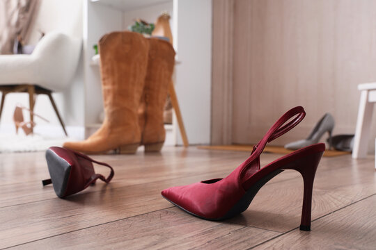 Stylish high heels on floor in hallway, closeup