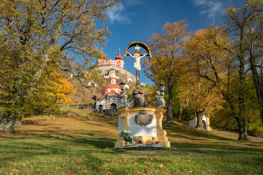 View of the Kalvaria Banska Stiavnica religious complex with historic chapels and autumn trees under a blue sky in Banska Stiavnica, Banskobystricky kraj, Slovakia.