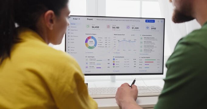 Couple budget planning on finance dashboard online. They review savings and monthly expenses on a computer at home using charts analytics for smarter choices. Clear concept of home finance teamwork