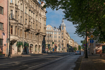 Obraz premium Kamennoostrovsky Prospekt in the Petrogradsky District and M. M. Gorbov's Apartment Building on Avstriyskaya square on on a sunny summer day, Saint Petersburg, Russia