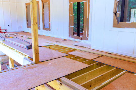 Work is ongoing to replace floor in porch with wooden beams unfinished wood boards