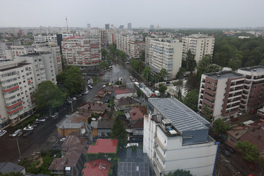 Overview of blocks of flats and traffic in Bucharest during a rainy late spring day.