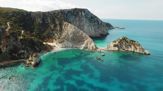 Aerial view of hidden beach Agia Eleni by rocky cliffs and sea in Cephalonia