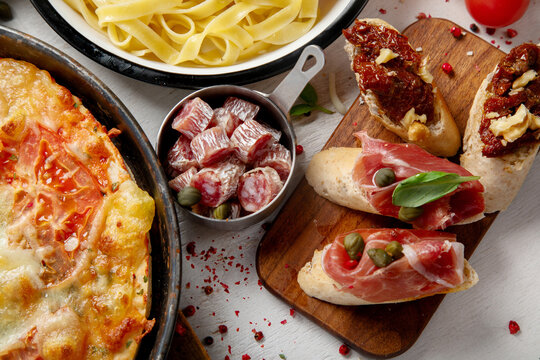 Italian cuisine. Pasta, pizza, olives and antipasto toasts.