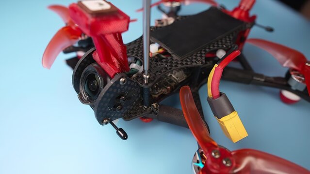 Close-up of drone with camera and remote control on blue background