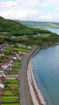 Vertical social ratio aerial video of the Glenarm coastal road, on the Causeway Coastal Route in County Antrim, Northern Ireland in the UK. Produced in 3840x2160 and with Rec709 color.