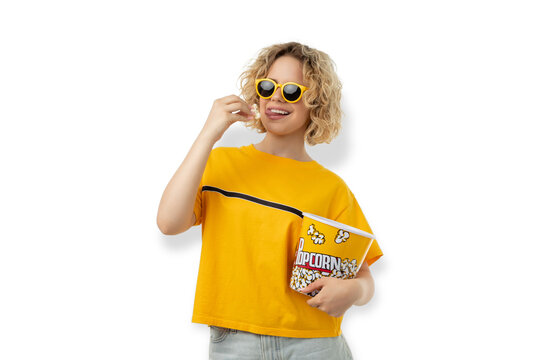 Woman holds popcorn and smiles in a casual outfit, PNG
