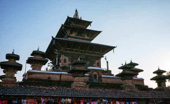 Ancient multi-tiered Newar pagoda temple rises against a clear blue sky at dusk in Nepal's Durbar Square.