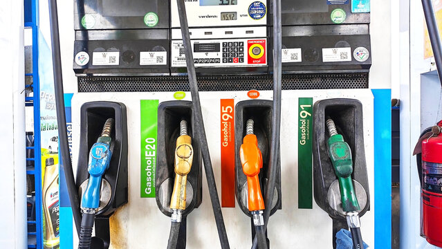 Fuel Pumps at Station: A close-up shot of fuel pumps, Gasohol 91, 95, E20, and Dieselat a gas station, showcasing different nozzle colors and fuel type labels. Thailand, June 18, 2026