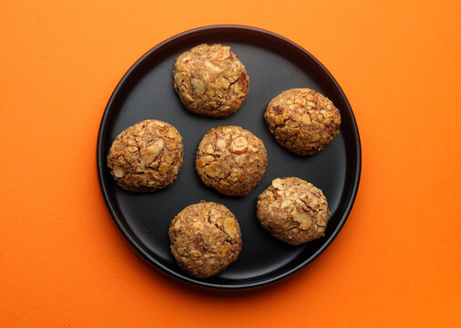 Indian cookies called ragi badam cookies isolated on orange background 