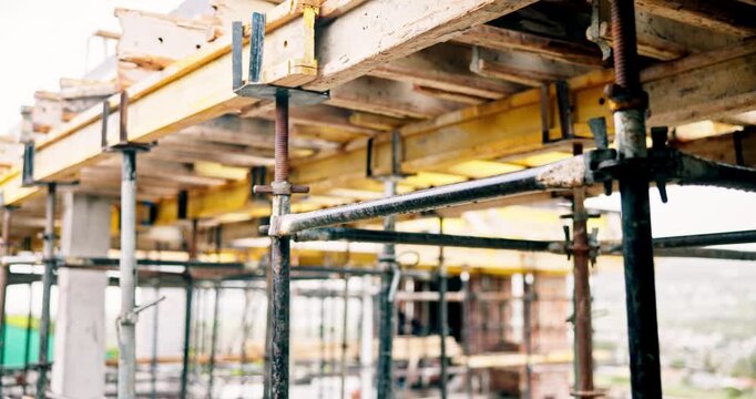 Beam, construction and empty site with scaffolding for building, renovation or structure support. Metal, exterior framework and upgrade project for house extension, civil engineering andr development